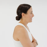 athlete wearing hair in low bun with dark brown adjustable scrunchie